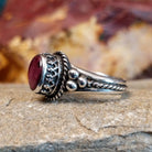 Purple spiny oyster shell ring with twisted rope accents and dot work.