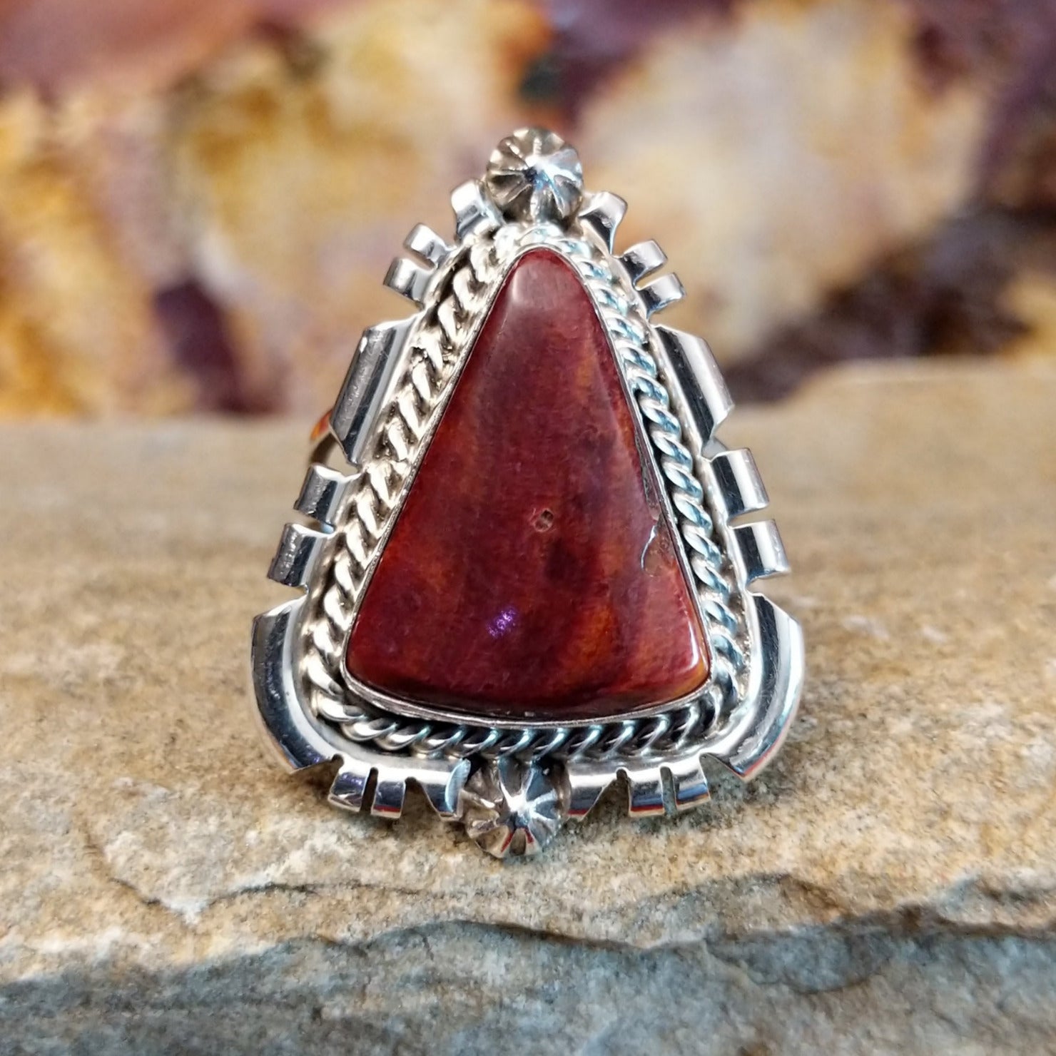 Intricate ridged accents on the silver setting with a purple spiny oyster shell set in it.