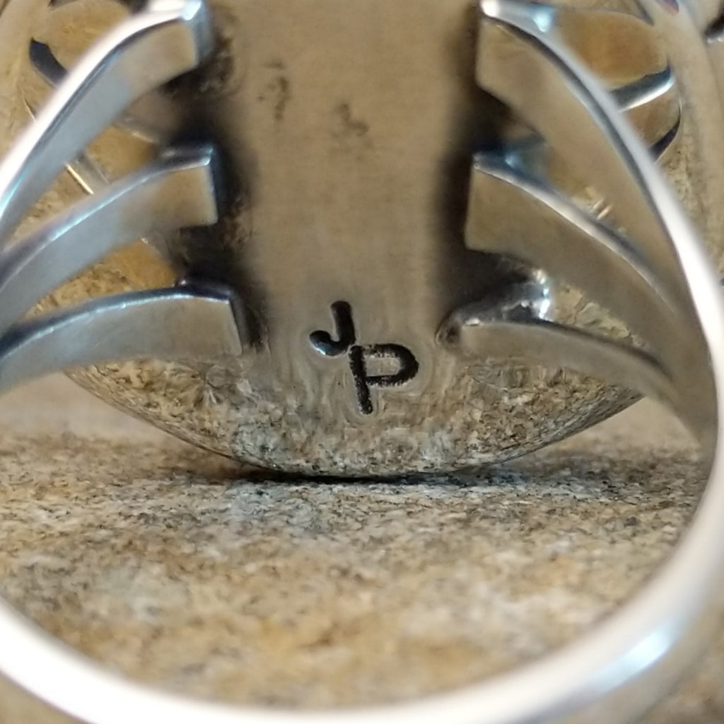 The initials are stamped onto the underside of the setting.