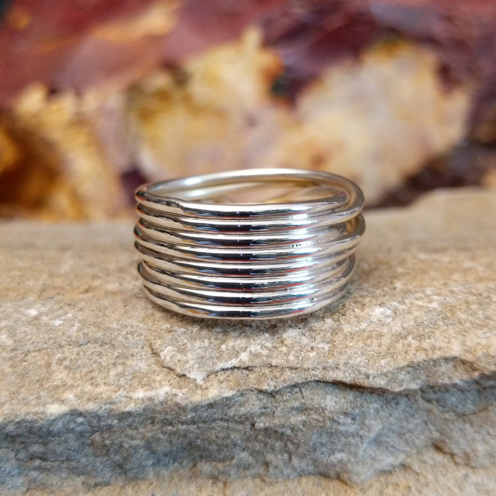 The thin, layered sterling silver band of the ring.