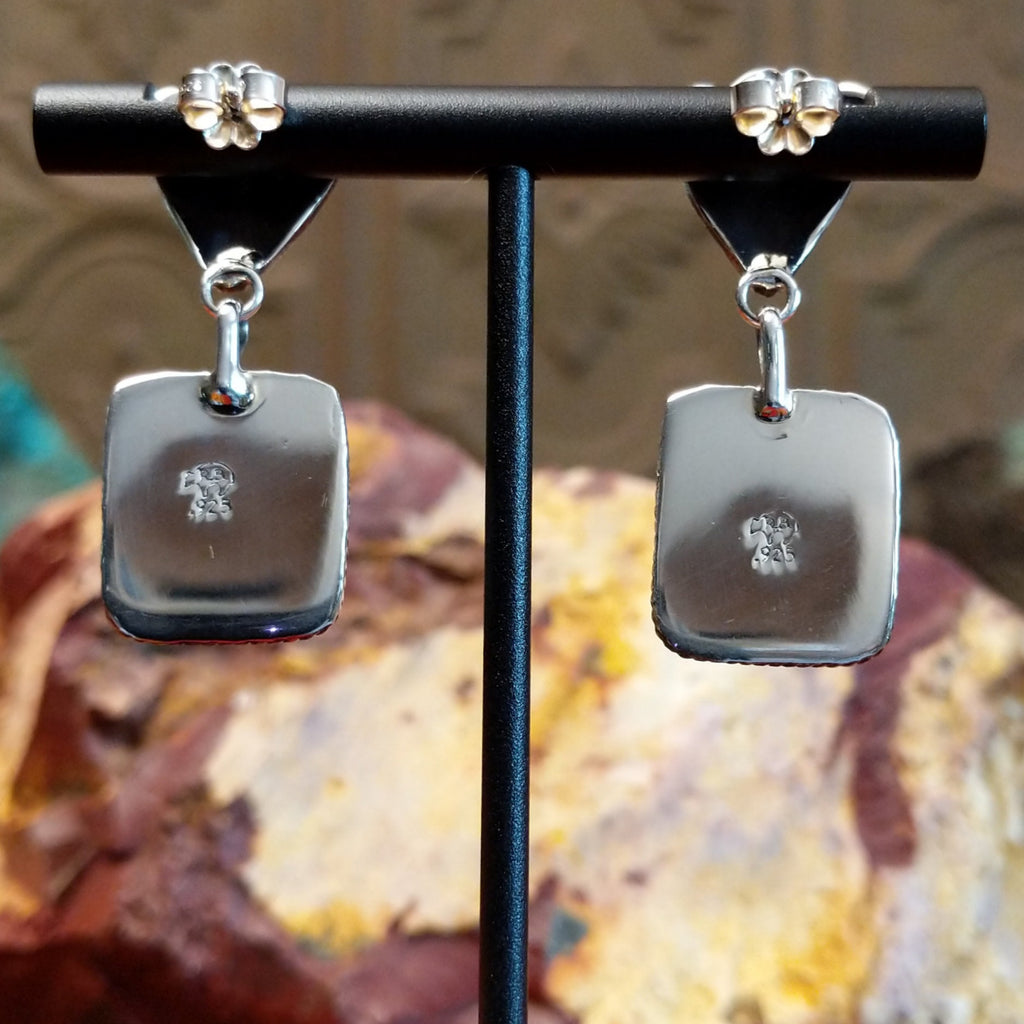 The backings feature the silver authentication stamped.