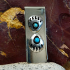 Two shadowbox bear claws set on the sterling silver face.