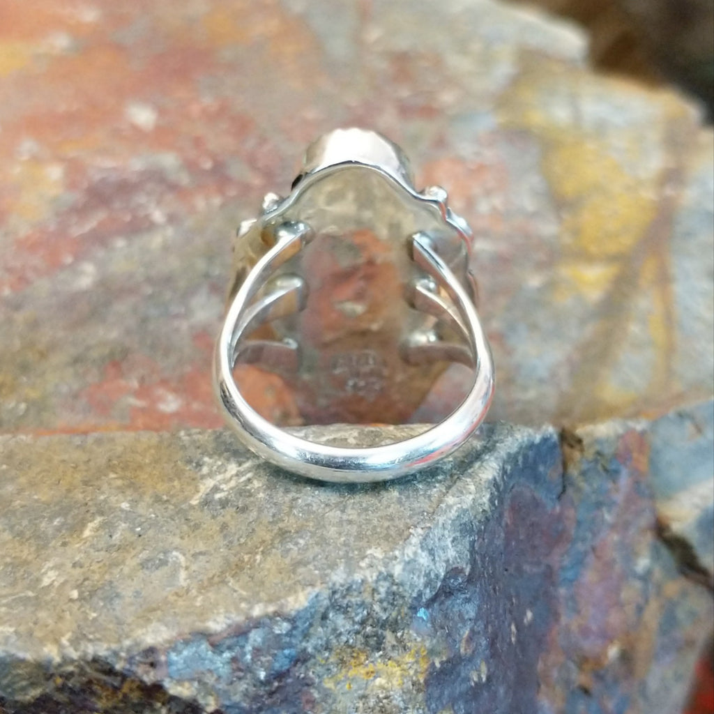 The tapered polished sterling silver band of the ring.