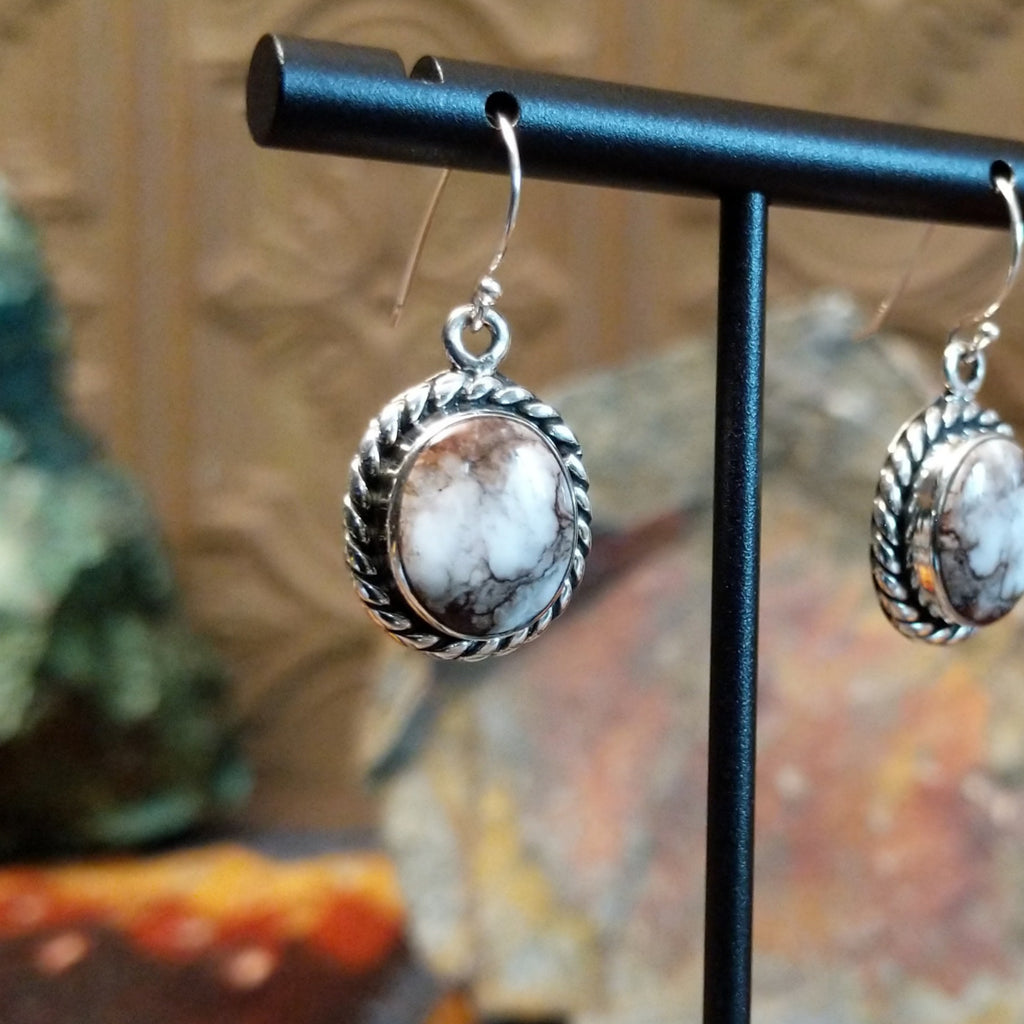 Round wild horse stones set in twisted rope silver bezels of the dangle earrings.