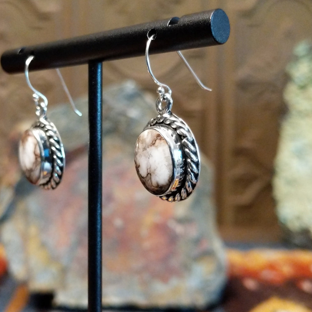 Round wild horse stones set in twisted rope silver bezels of the dangle earrings.