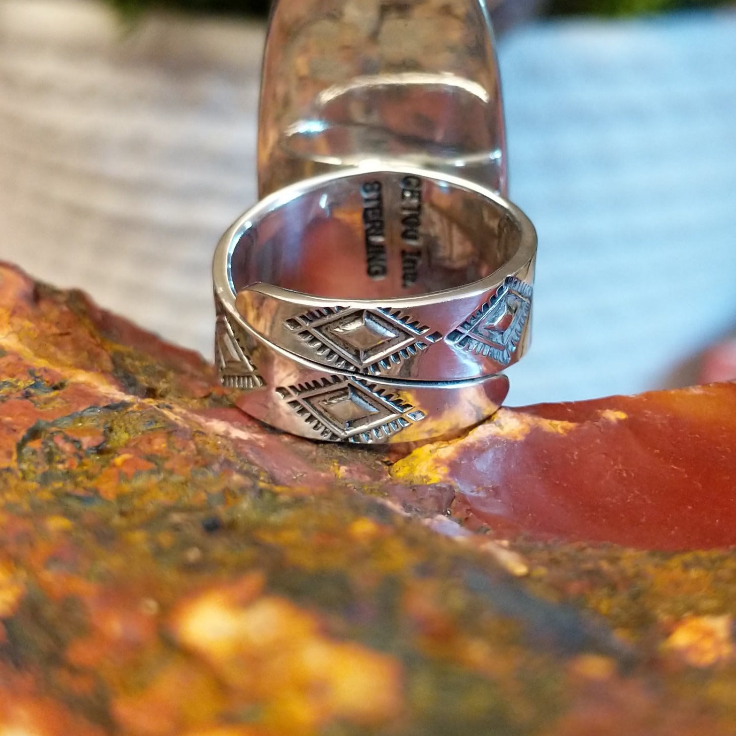 Tufa cast sterling silver ring with large malachite stone set in the bezel and stamping on the band.