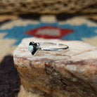 Navajo manmade opal heart ring, featuring a heart-shaped shimmering opal with vibrant flashes of color set in a handcrafted sterling silver band.  Side view.