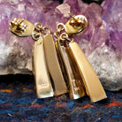 The back of the earrings showcase the authentication marks.