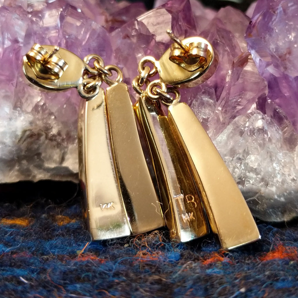 The back of the earrings showcase the authentication marks.