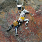 Handcrafted sterling silver multistone horse pendant by V.Y., featuring a traditional Navajo inlay horse design.