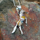 Handcrafted sterling silver multistone horse pendant by V.Y., featuring a traditional Navajo inlay horse design; side view.
