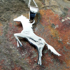 Handcrafted sterling silver multistone horse pendant by V.Y., featuring a traditional Navajo inlay horse design; artisan and Sterling Silver stamp.