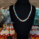 Sterling silver necklace and earring set with orange and red spiny oyster shell, turquoise, lapis, charoite, and manmade opal inlaid.