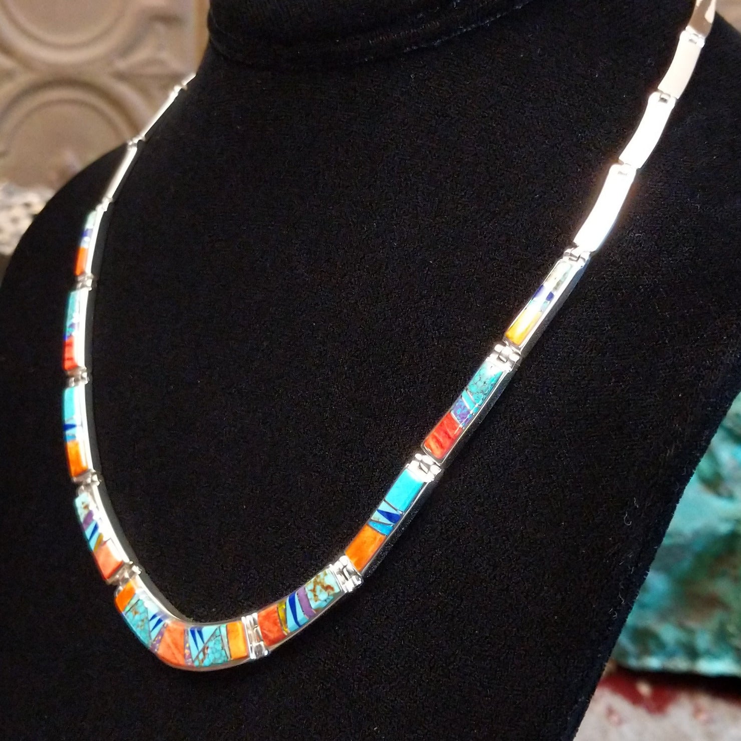 Sterling silver necklace and earring set with orange and red spiny oyster shell, turquoise, lapis, charoite, and manmade opal inlaid.