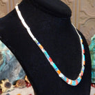 Sterling silver necklace and earring set with orange and red spiny oyster shell, turquoise, lapis, charoite, and manmade opal inlaid.