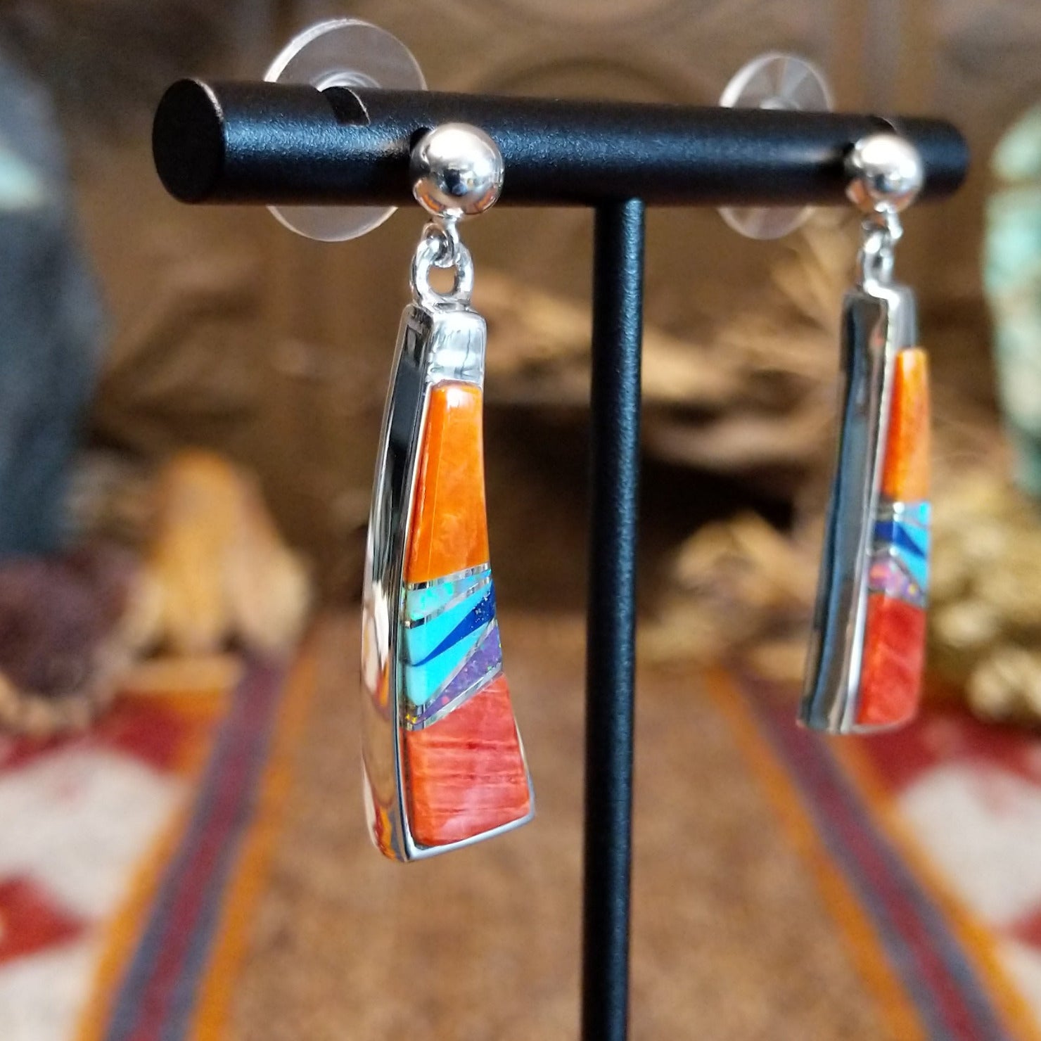 Sterling silver earrings with orange and red spiny oyster shell, turquoise, lapis, charoite, and manmade opal inlaid.