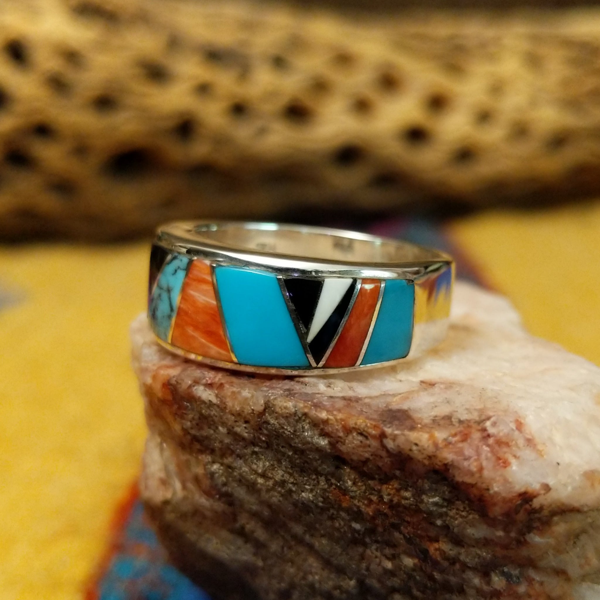Navajo multistone inlay ring, featuring a colorful arrangement of natural stones set in a handcrafted sterling silver band with traditional Southwestern-inspired craftsmanship.  Side view.
