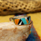 Navajo multistone inlay ring, featuring a colorful arrangement of natural stones set in a handcrafted sterling silver band with traditional Southwestern-inspired craftsmanship.  Side view.