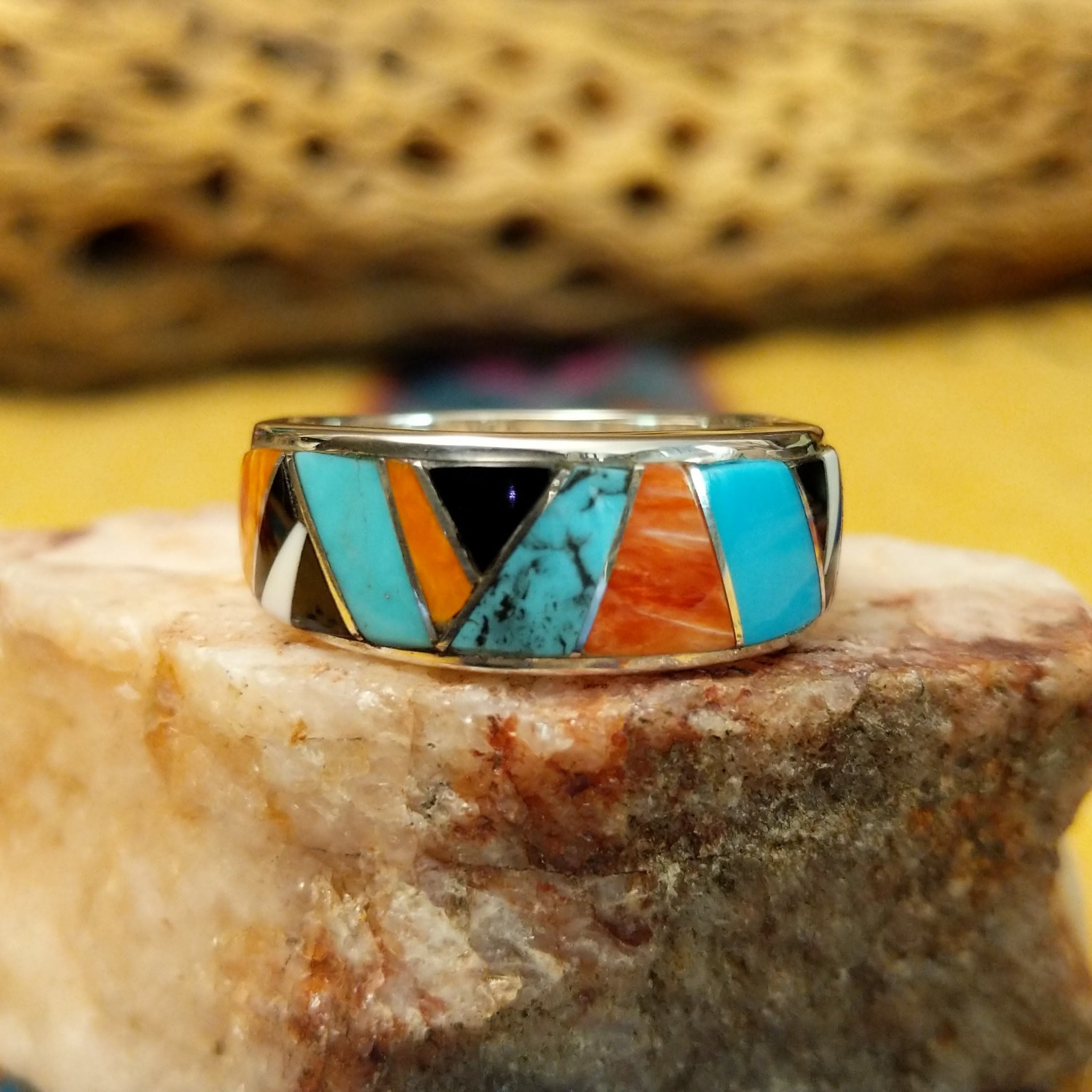 Navajo multistone inlay ring, featuring a colorful arrangement of natural stones set in a handcrafted sterling silver band with traditional Southwestern-inspired craftsmanship.