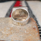 Navajo multistone inlay ring by B.J. with a square geometric design in brown, tan, black, and white stones separated by fine silver channels and set in polished silver; underside view.