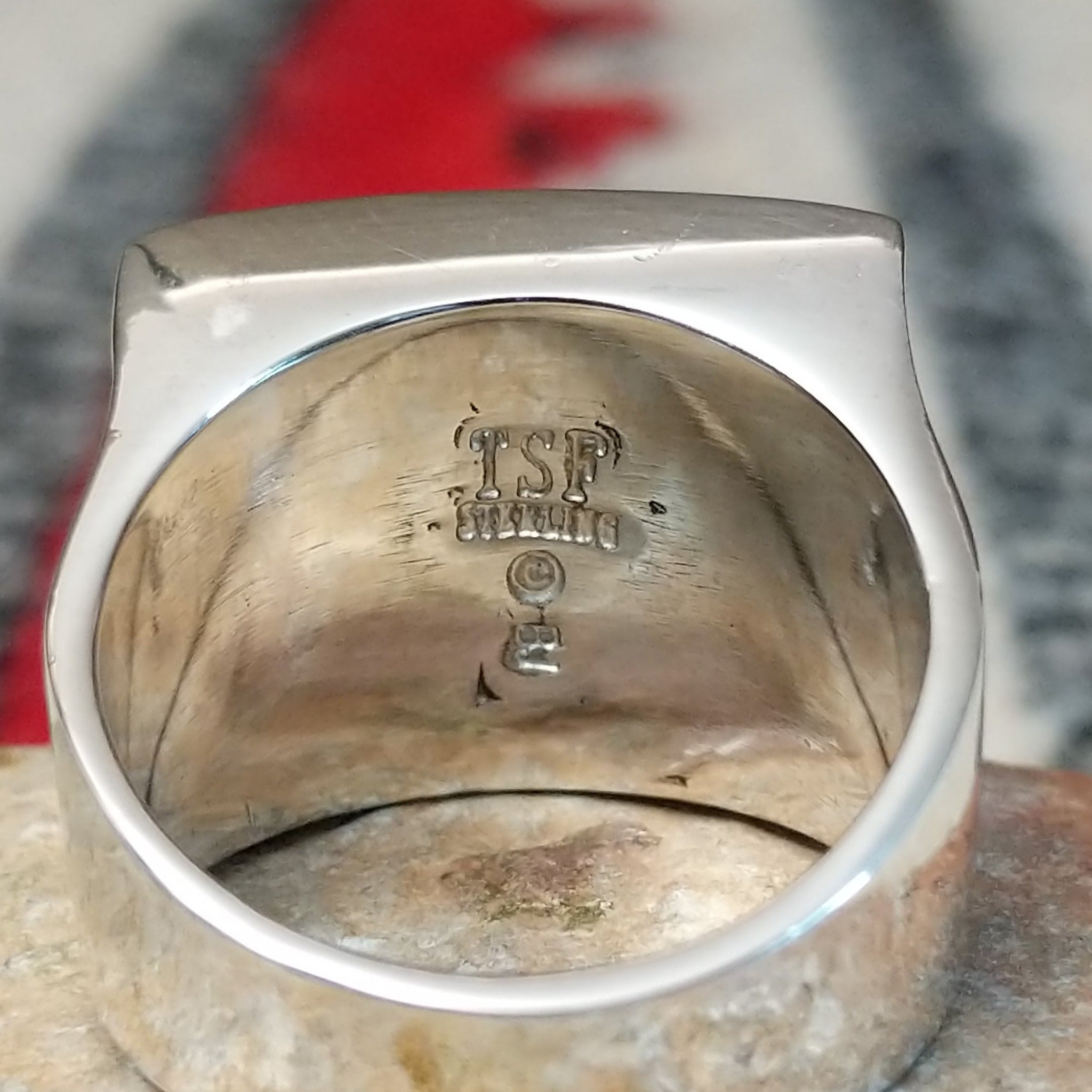 Navajo multistone inlay ring by B.J. with a square geometric design in brown, tan, black, and white stones separated by fine silver channels and set in polished silver; artisan and Sterling Silver stamp.