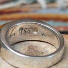 Navajo sterling silver ring by J.C. featuring geometric multistone inlay with black onyx, tiger’s eye, and assorted natural stones separated by silver dividers; artisan and Sterling Silver stamp.