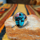Navajo Multistone Inlay Ring by P.D. featuring an oval geometric mosaic of turquoise, black onyx, and contrasting stone inlays separated by thin silver dividers, set in a wide, polished silver band.