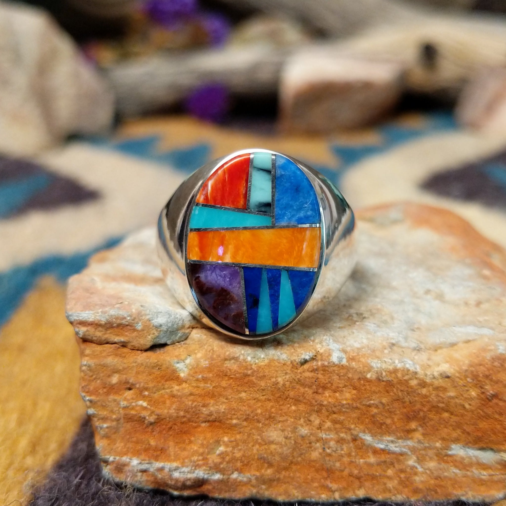 Sterling silver Navajo multistone inlay ring by P.D. featuring turquoise, red and orange spiny oyster shell, lapis, and geometric Southwestern inlay design.