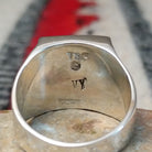 Navajo multistone inlay ring by V.Y. featuring a rectangular geometric design with turquoise, blue, purple, green, orange, and white inlay set in a wide polished silver band; artisan and Sterling Silver stamp.