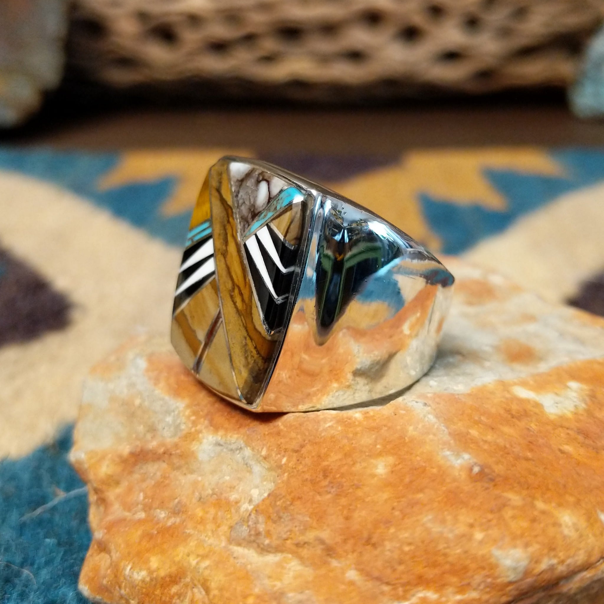 Handcrafted Navajo sterling silver ring by B.J. featuring a bold geometric inlay design in a polished silver setting with a contemporary Southwestern style; side view.