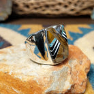 Handcrafted Navajo sterling silver ring by B.J. featuring a bold geometric inlay design in a polished silver setting with a contemporary Southwestern style; side view.