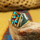 Navajo multistone mosaic ring, featuring a colorful mosaic of natural stones set in a handcrafted sterling silver band with traditional Southwestern-inspired craftsmanship. Side view.