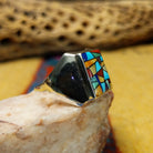 Navajo multistone mosaic ring, featuring a colorful mosaic of natural stones set in a handcrafted sterling silver band with traditional Southwestern-inspired craftsmanship.  Side view.