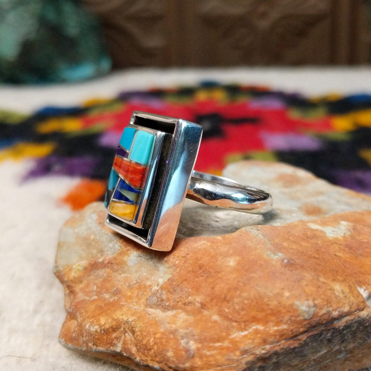 Navajo multistone mosaic shadowbox ring by A.Y. with geometric inlay and rectangular silver frame.