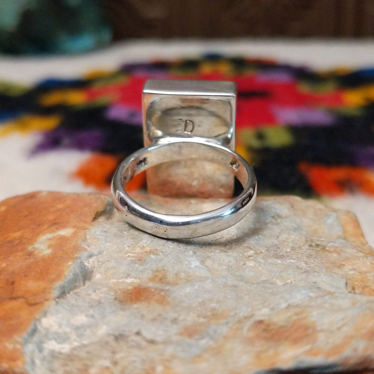 Navajo multistone mosaic shadowbox ring by A.Y. with geometric inlay and rectangular silver frame.