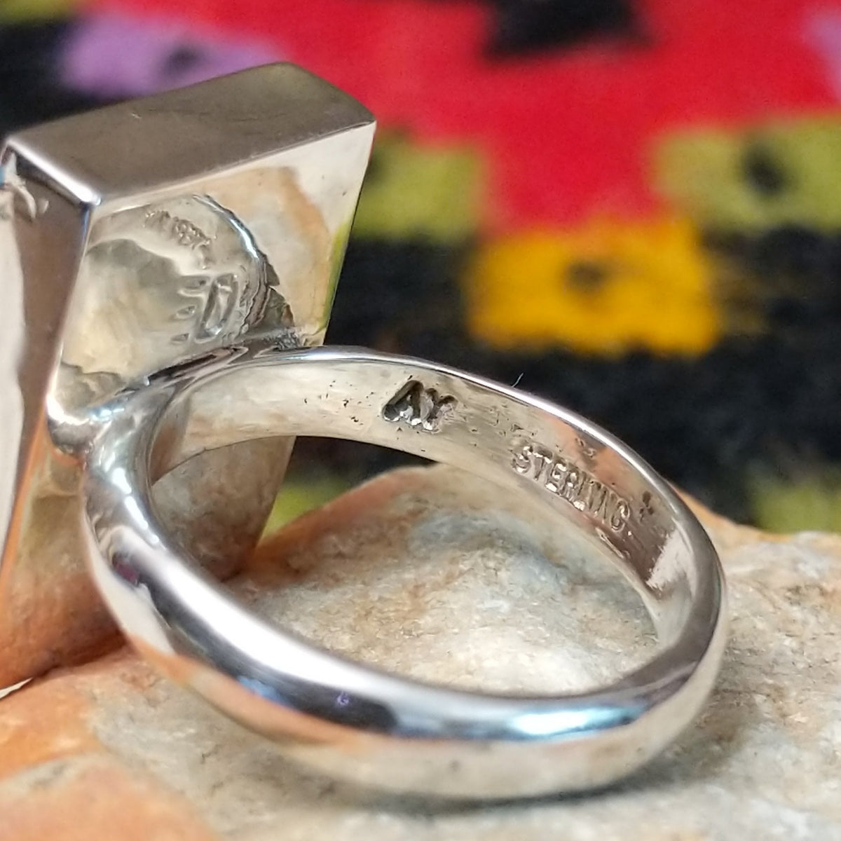 Navajo multistone mosaic shadowbox ring by A.Y. with geometric inlay and rectangular silver frame. Close up of the artist's stamped signature.