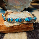 Navajo multistone inlay bracelet by V.J. with turquoise, lapis, and Mother of Pearl teardrop links in sterling silver.