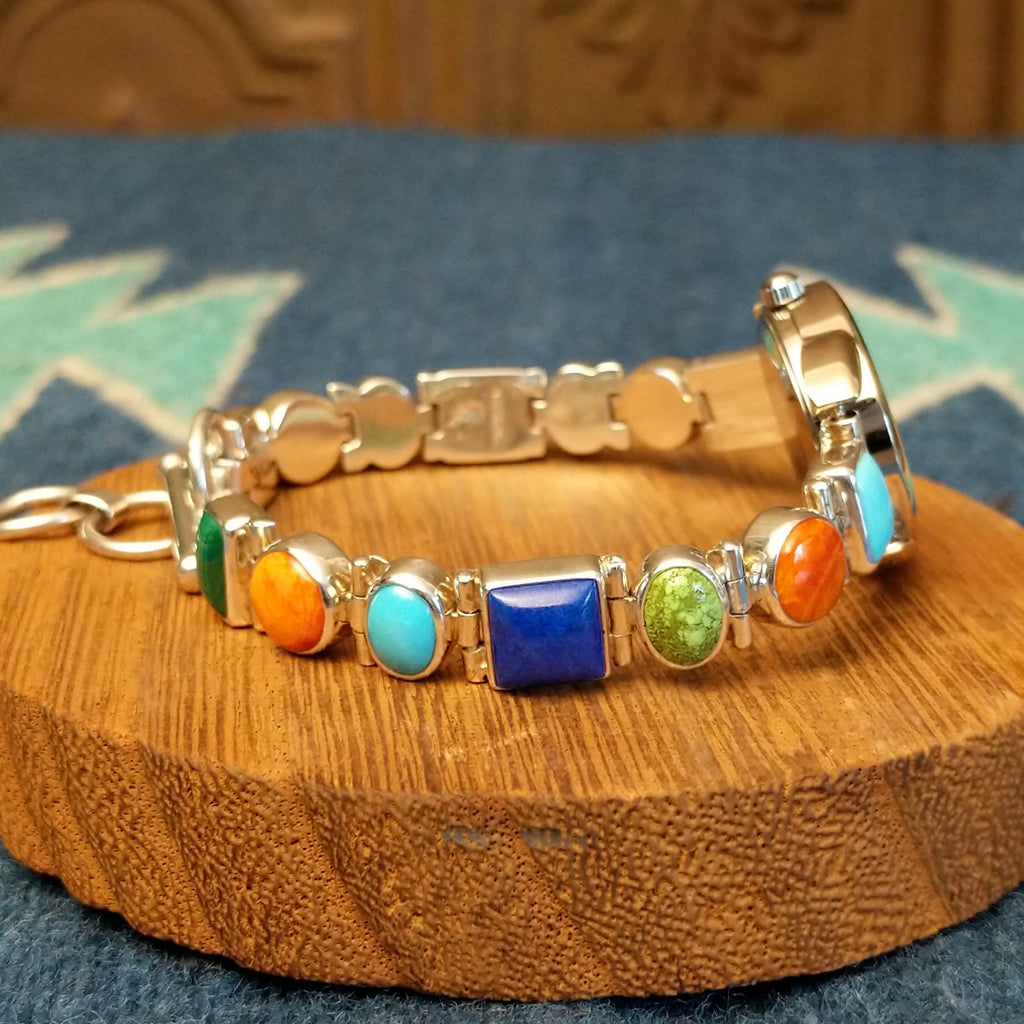 Vibrant, multistone watch linked together with a semi-adjustable clasp.