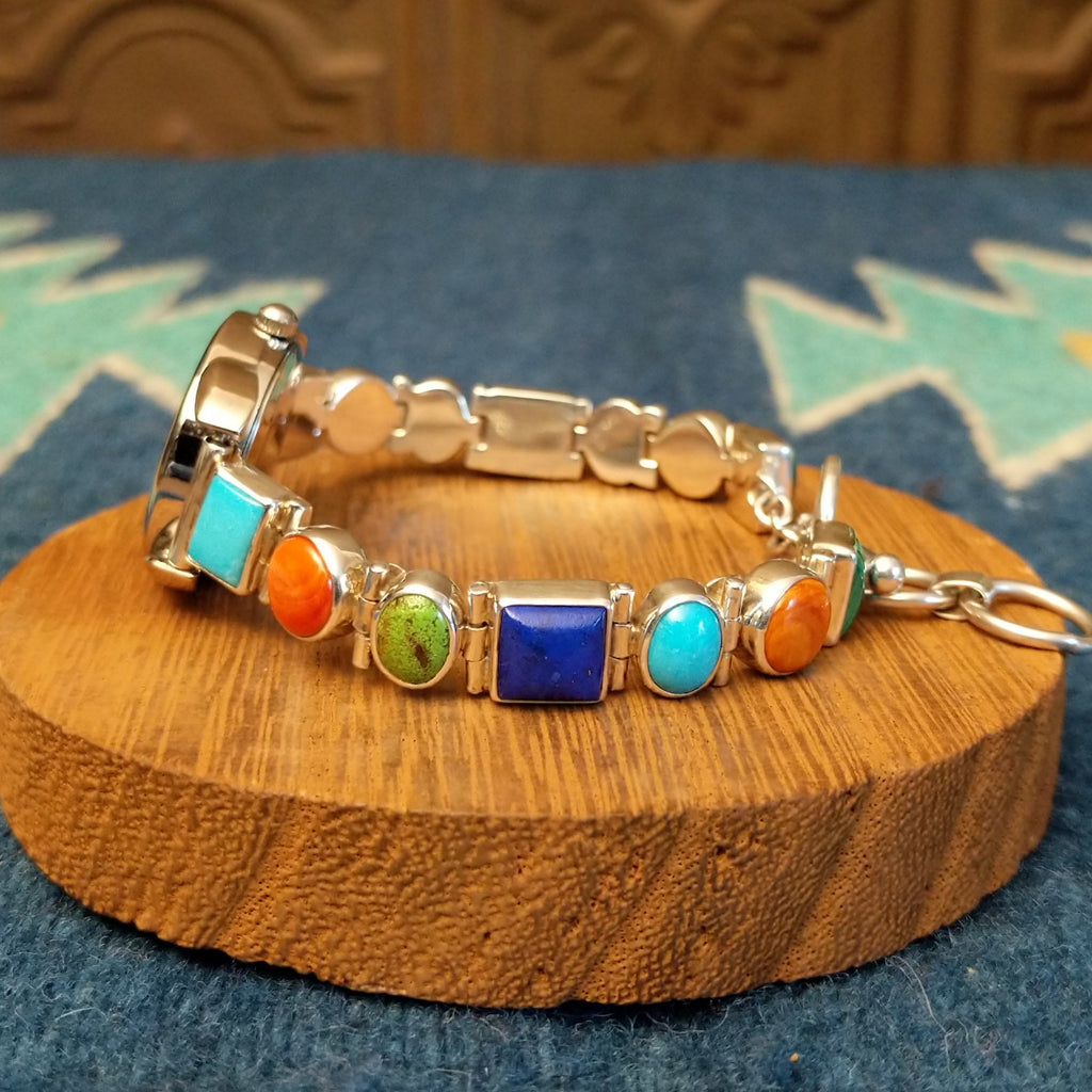 Vibrant, multistone watch linked together with a semi-adjustable clasp.