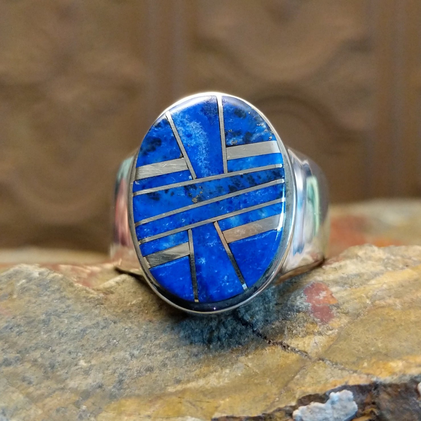 Sterling silver ring with round bezel and inlaid lapis.