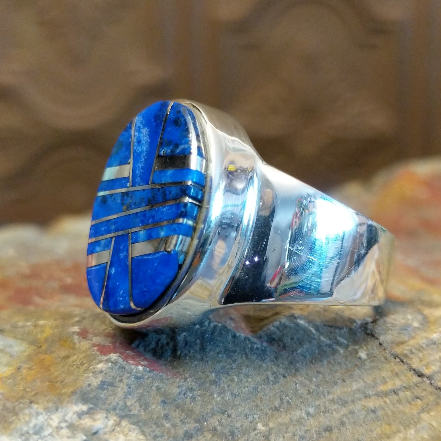 Sterling silver ring with round bezel and inlaid lapis.