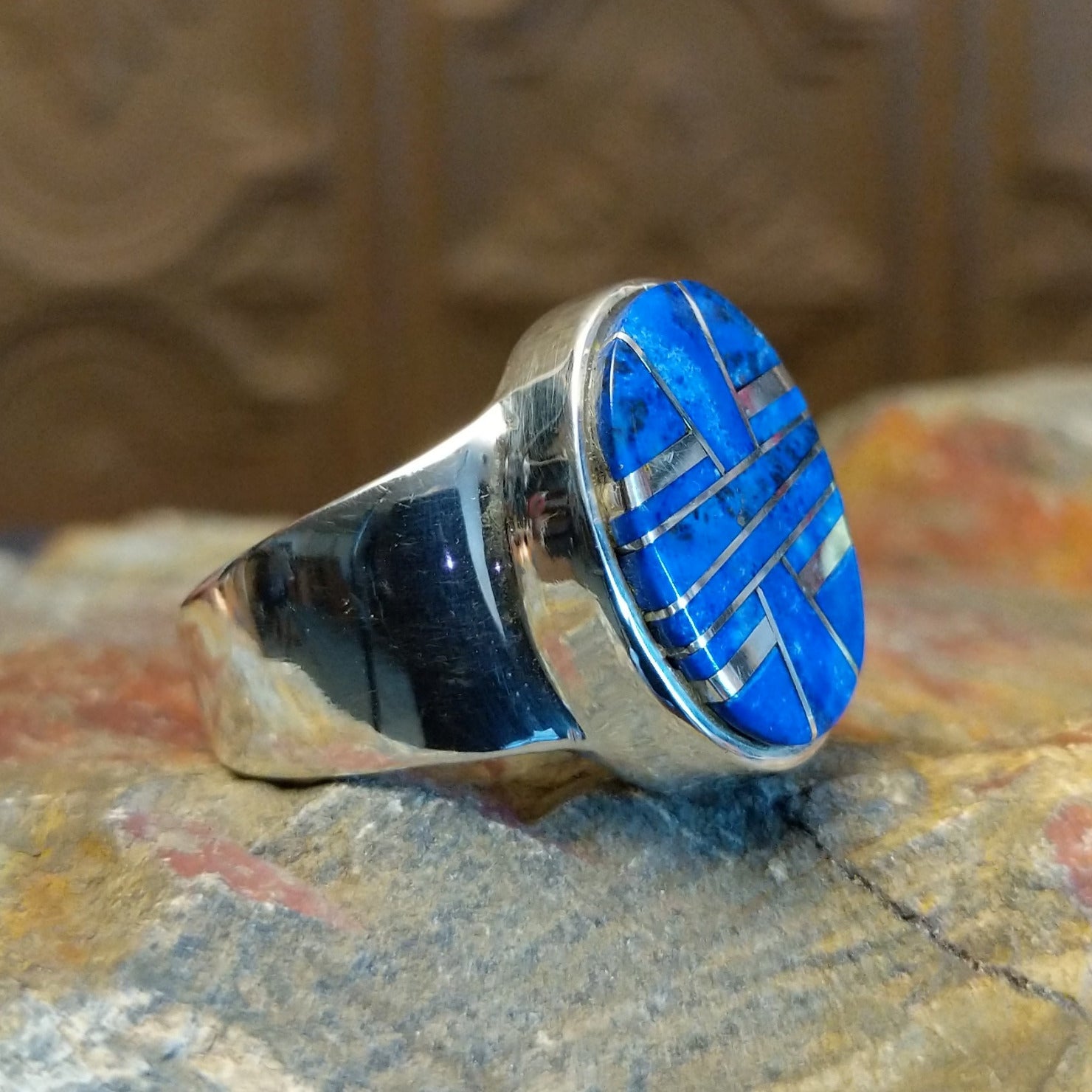 Sterling silver ring with round bezel and inlaid lapis.