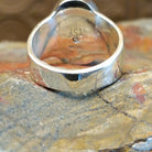Sterling silver ring with round bezel and inlaid lapis.