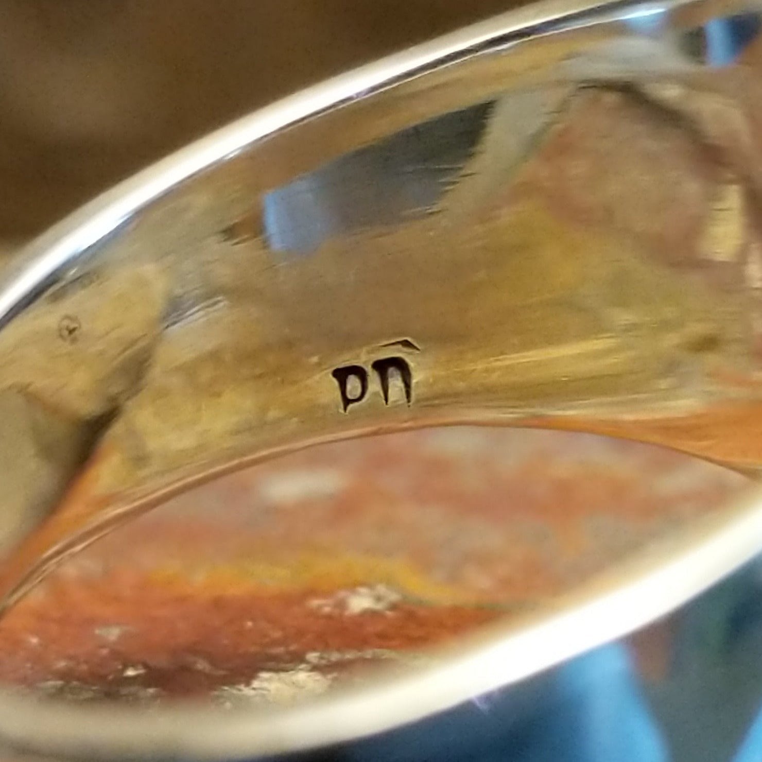 Close-up of the artisan's stamped signature.
