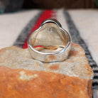 Navajo oval multistone inlay ring by E.D. featuring turquoise, blue, green, and purple stones arranged in a geometric mosaic with silver channel accents and a polished silver band; underside view.