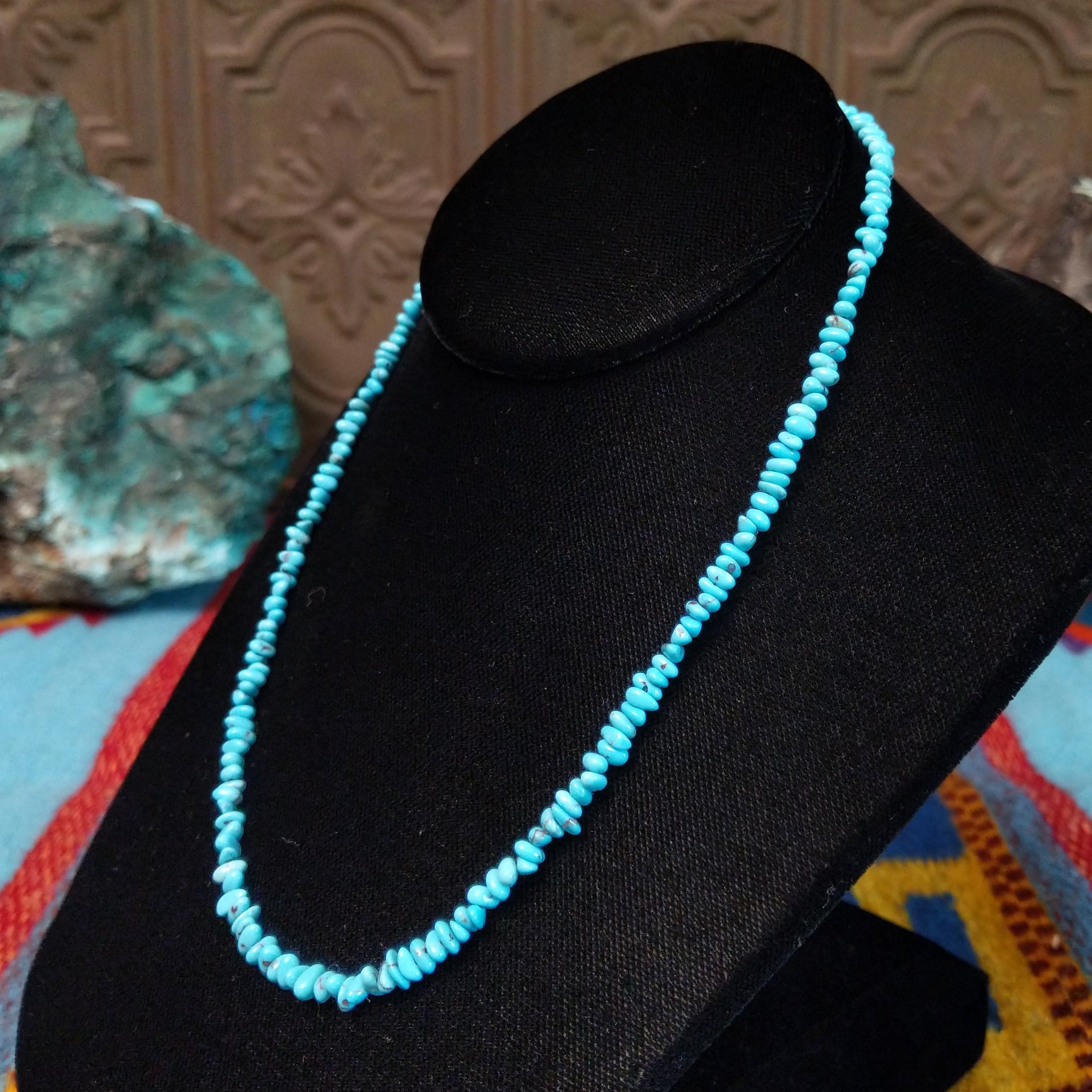 Long single-strand necklace of small, irregular blue-green turquoise nugget beads