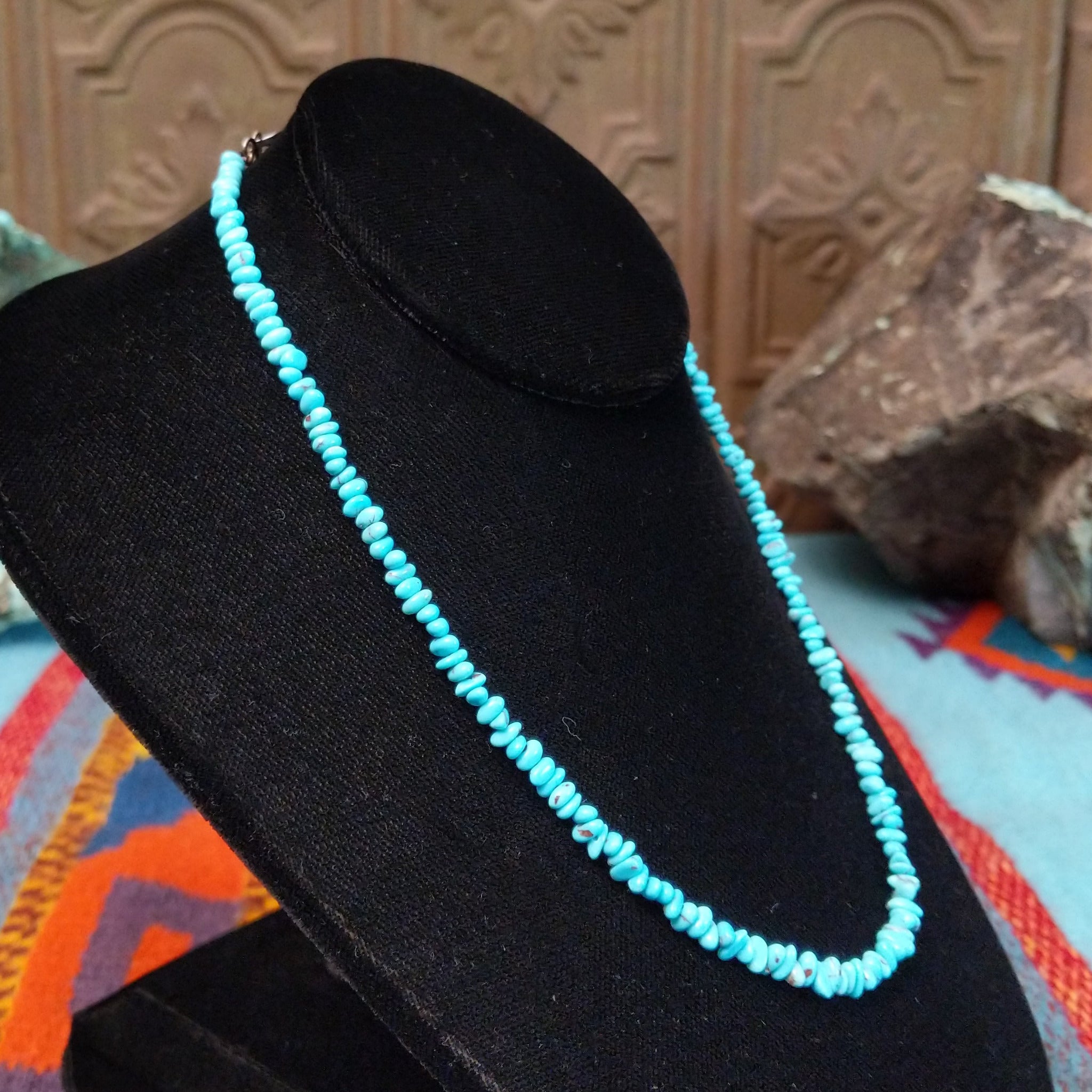 Long single-strand necklace of small, irregular blue-green turquoise nugget beads