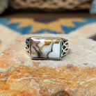 Handcrafted Navajo sterling silver ring featuring a rectangular Wild Horse gemstone with natural white, brown, and golden veining, set in a smooth bezel with openwork cutout details on the band.