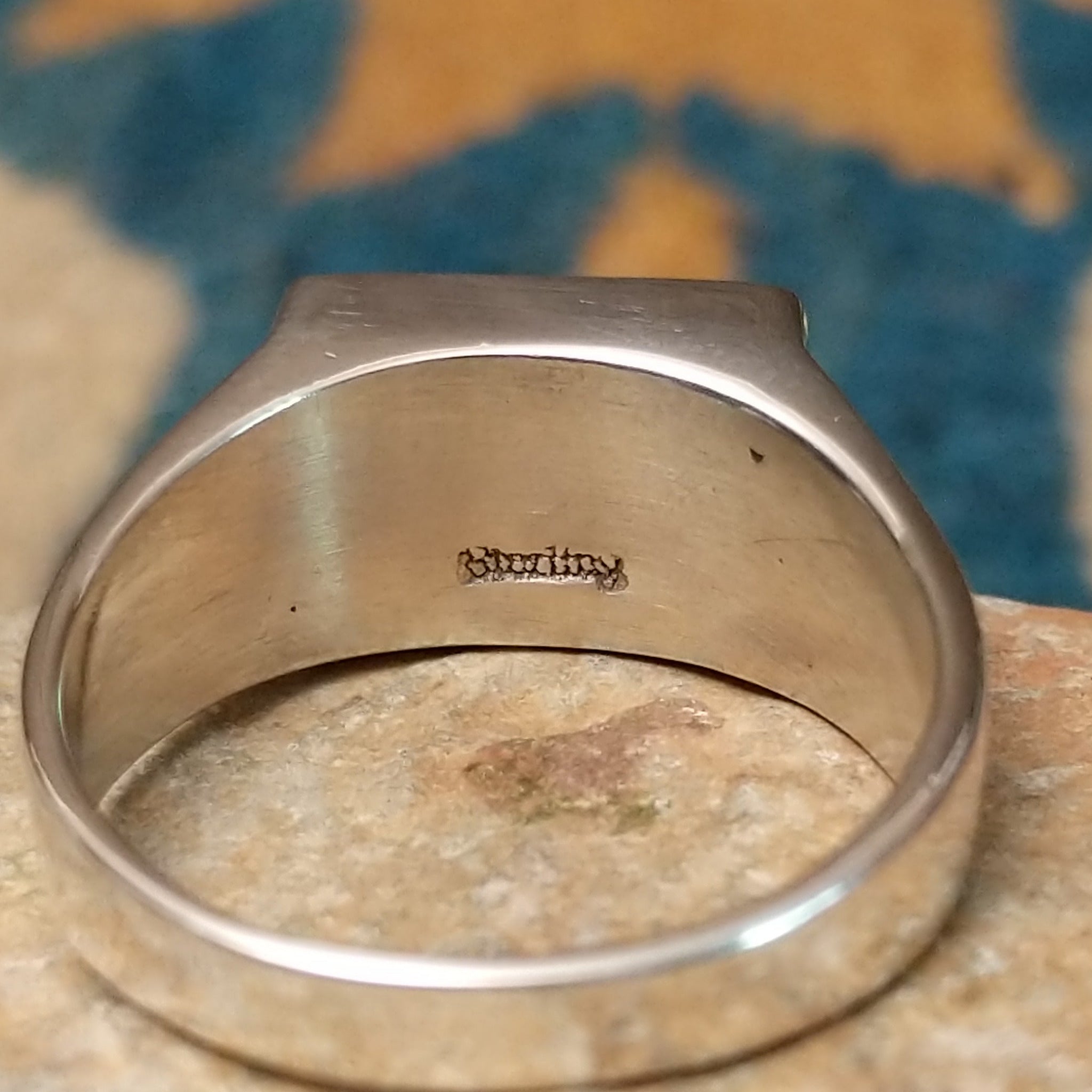 Handcrafted Navajo sterling silver ring featuring a rectangular Wild Horse gemstone with natural white, brown, and golden veining, set in a smooth bezel with openwork cutout details on the band; Sterling Silver stamp.