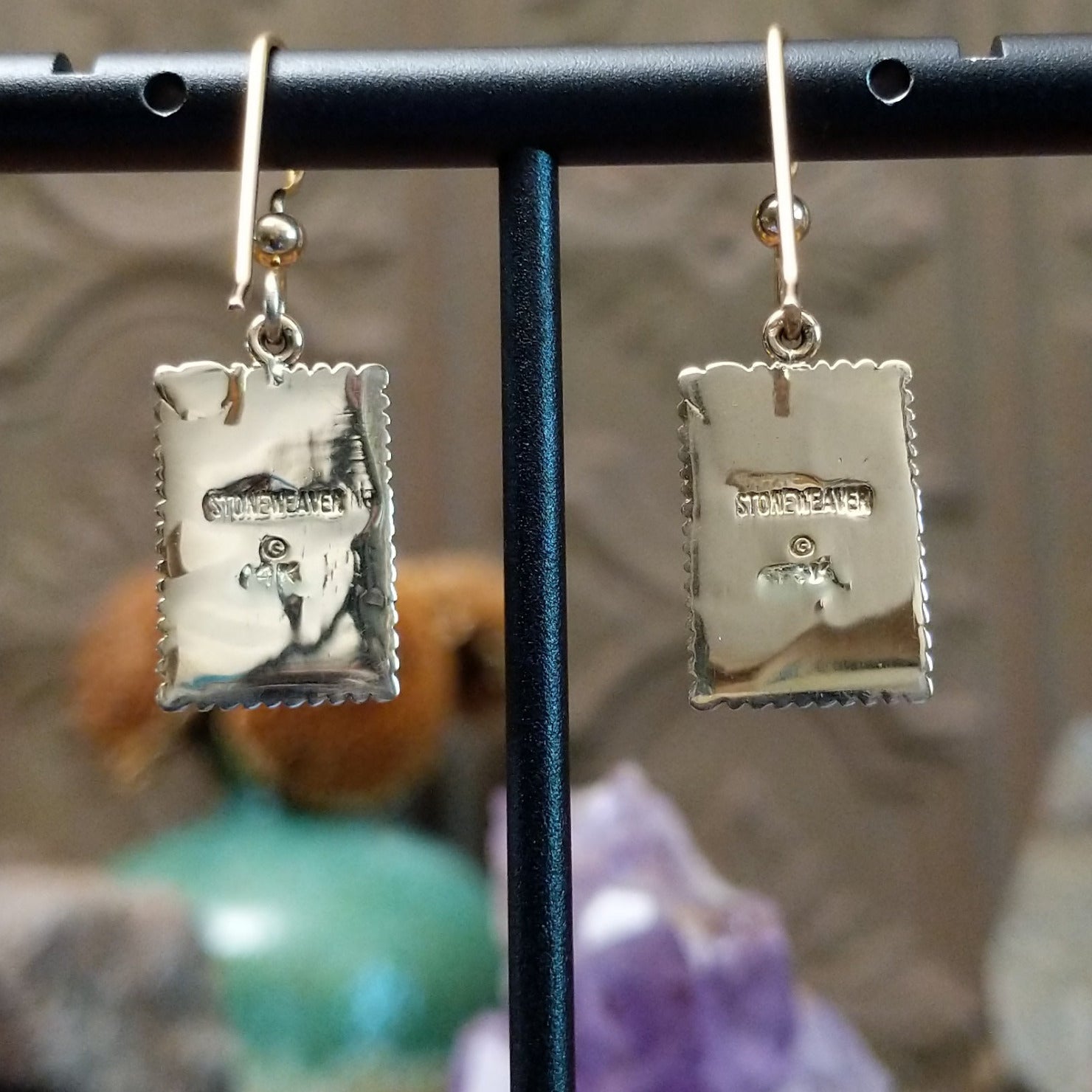 Close up of earring backing and stamped 14K indicating 14 karat gold construction.